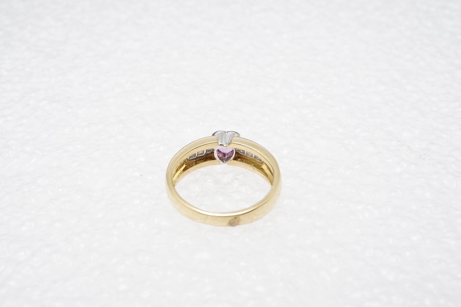 A pink sapphire and diamond ring